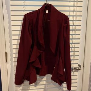 Burgundy fitted blazer. Open f front with ruffles